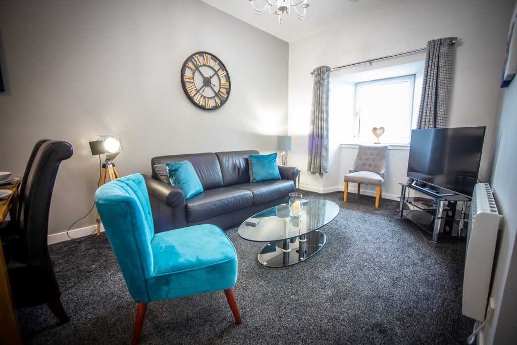 Brodie Apartment's living area with smart TV, located within Douglas House Apartments- Caledonia Apartments